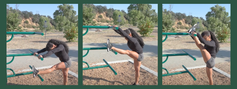 A person is performing leg stretches using outdoor exercise equipment in a park.