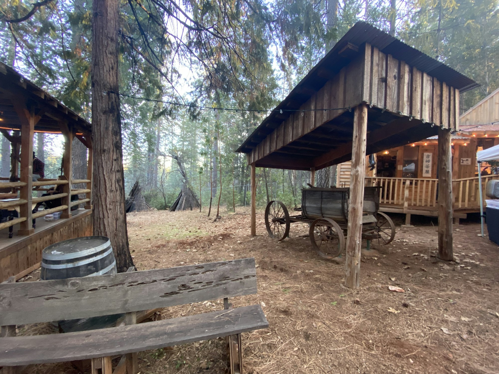 May contain: housing, building, cabin, house, bench, furniture, wood, wheel, machine, person, and human