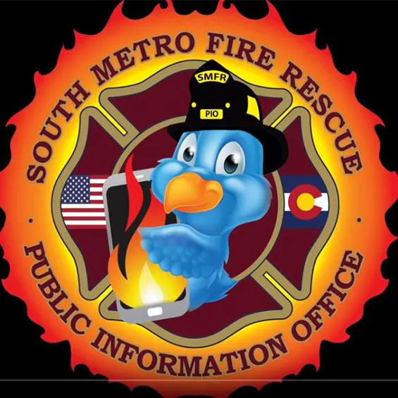 Cartoon bird in a fire hat holding a smartphone with flames, surrounded by “SOUTH METRO FIRE RESCUE PUBLIC INFORMATION OFFICE.”