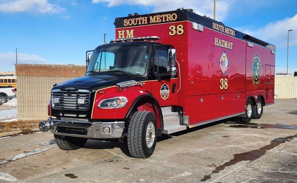 Red hazmat emergency vehicle labeled "South Metro 38" parked on concrete.