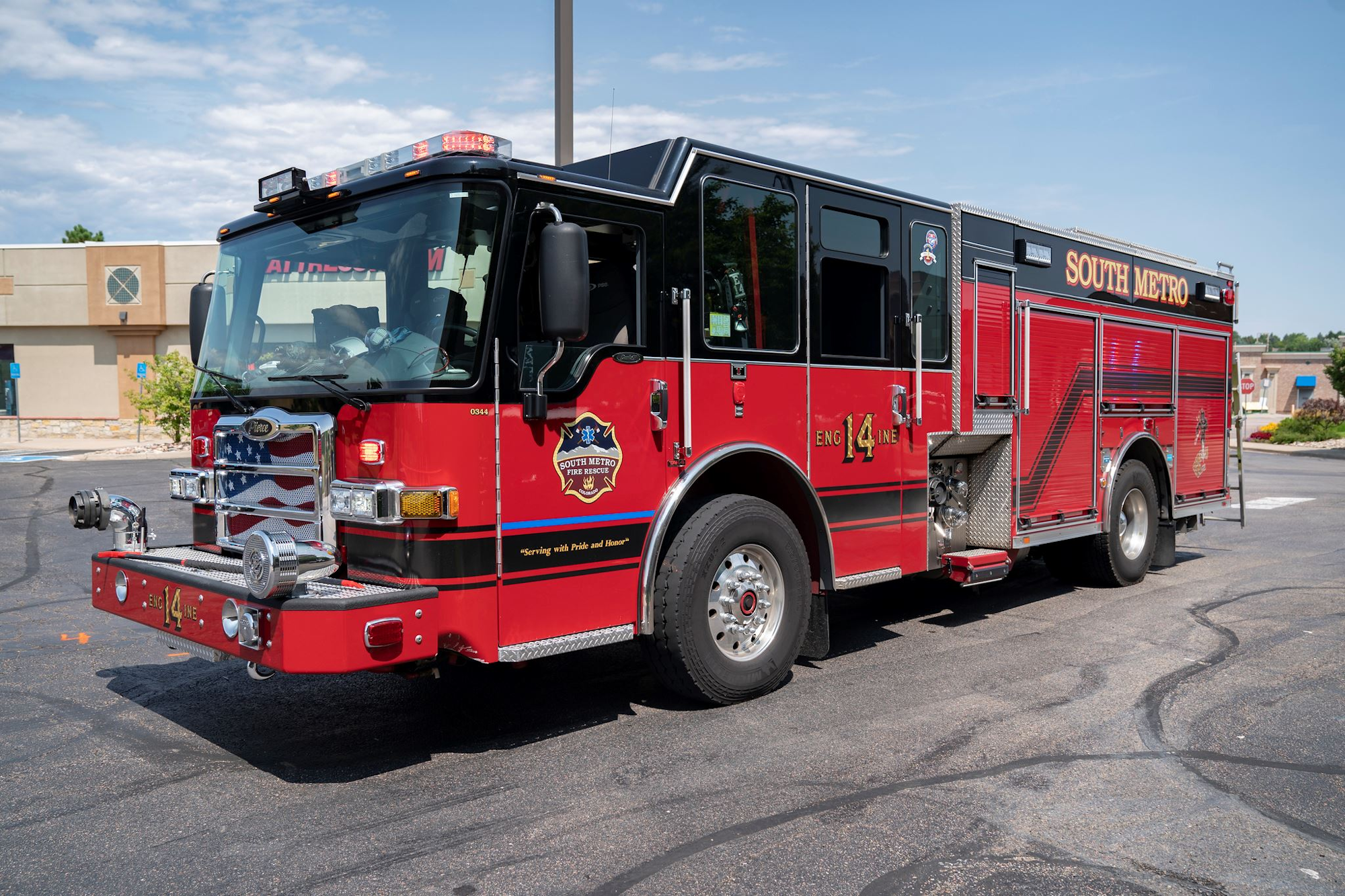 Red South Metro fire truck parked in a lot, sunny day.
