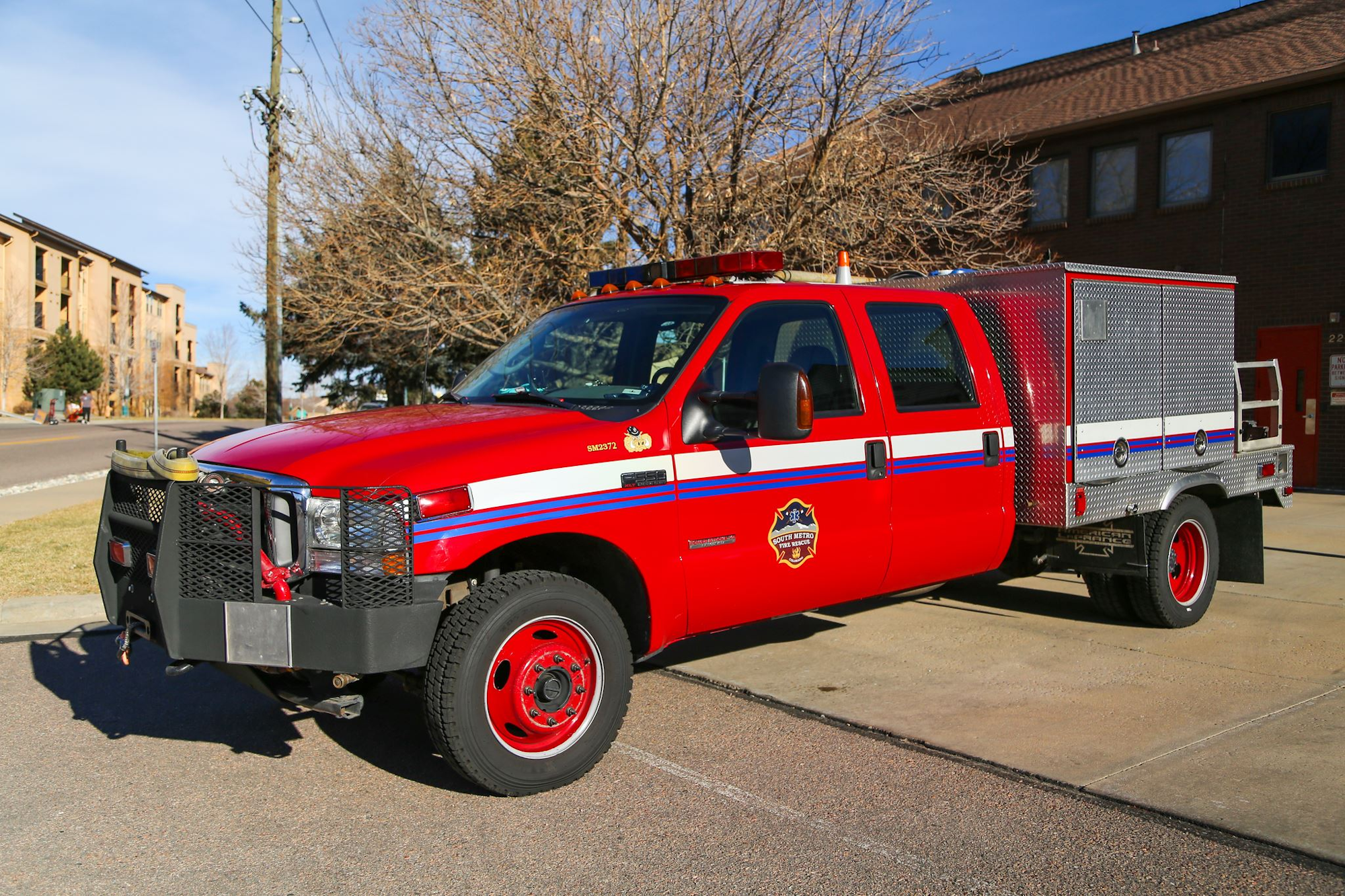 Red fire department utility vehicle parked outdoors.