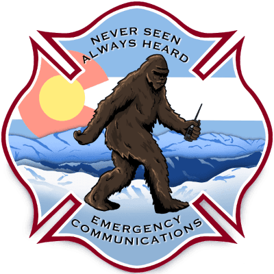 A Bigfoot holding a radio, with the text "Never Seen Always Heard Emergency Communications," over a mountain and flag background.
