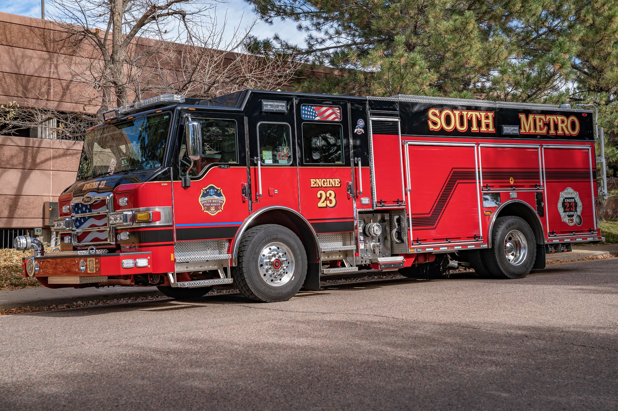 Red and black fire truck labeled "South Metro, Engine 23" parked on a street.
