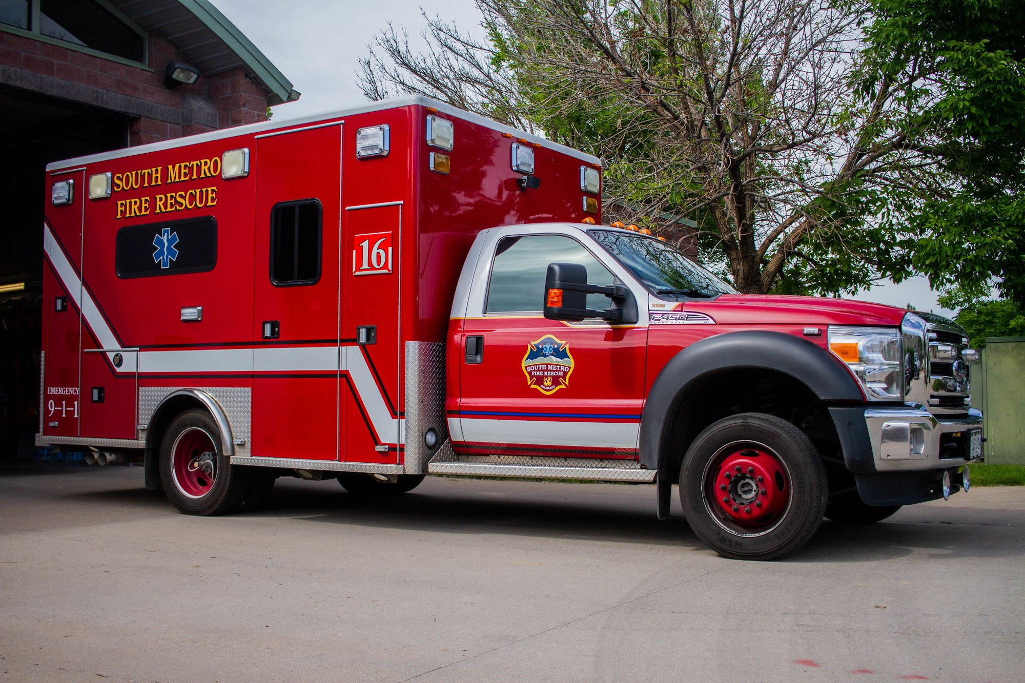 Red South Metro Fire Rescue ambulance parked outside a building.