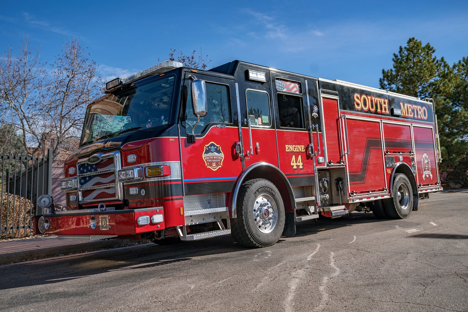 A red fire truck labeled "SOUTH METRO" and "ENGINE 44" parked on a sunny day.
