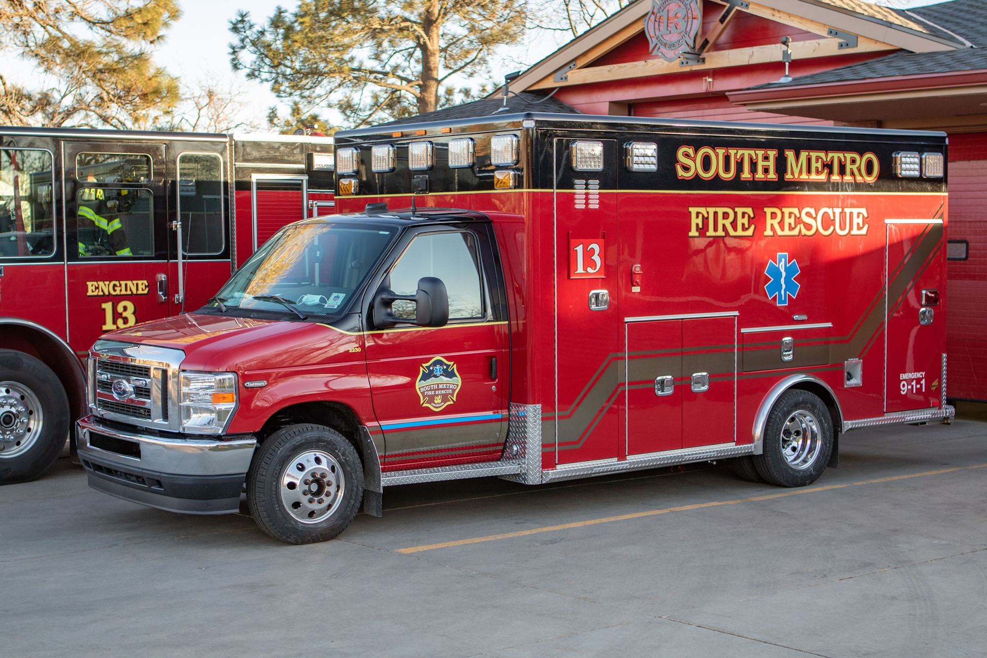 Red fire rescue vehicle labeled "South Metro Fire Rescue" parked next to a fire engine.