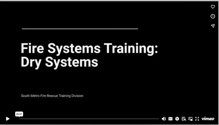 The image features a title slide for a video on "Fire Systems Training: Dry Systems" by South Metro Fire Rescue Training Division.