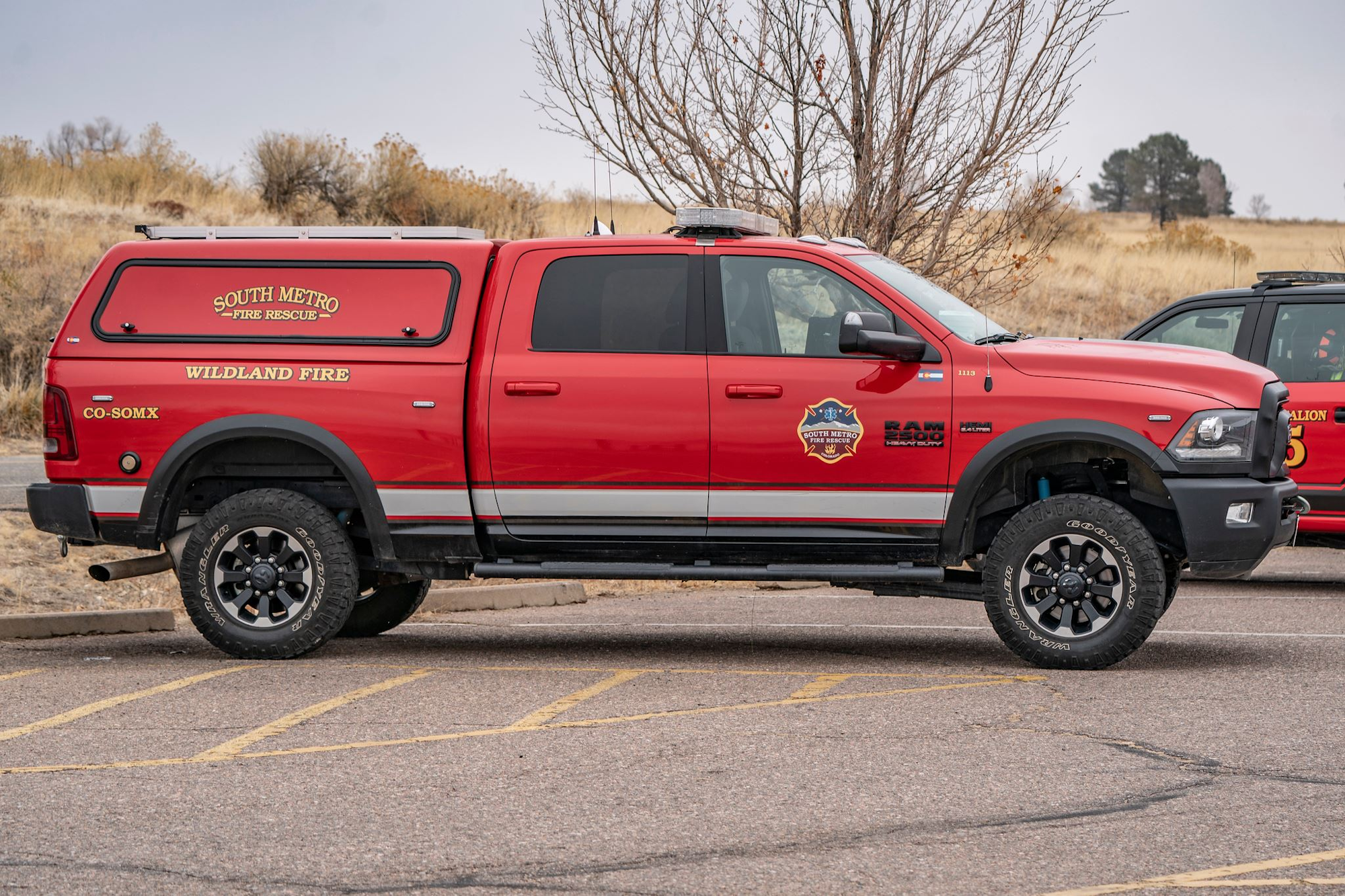 A red South Metro Fire Rescue truck labeled "Wildland Fire" parked in a lot.