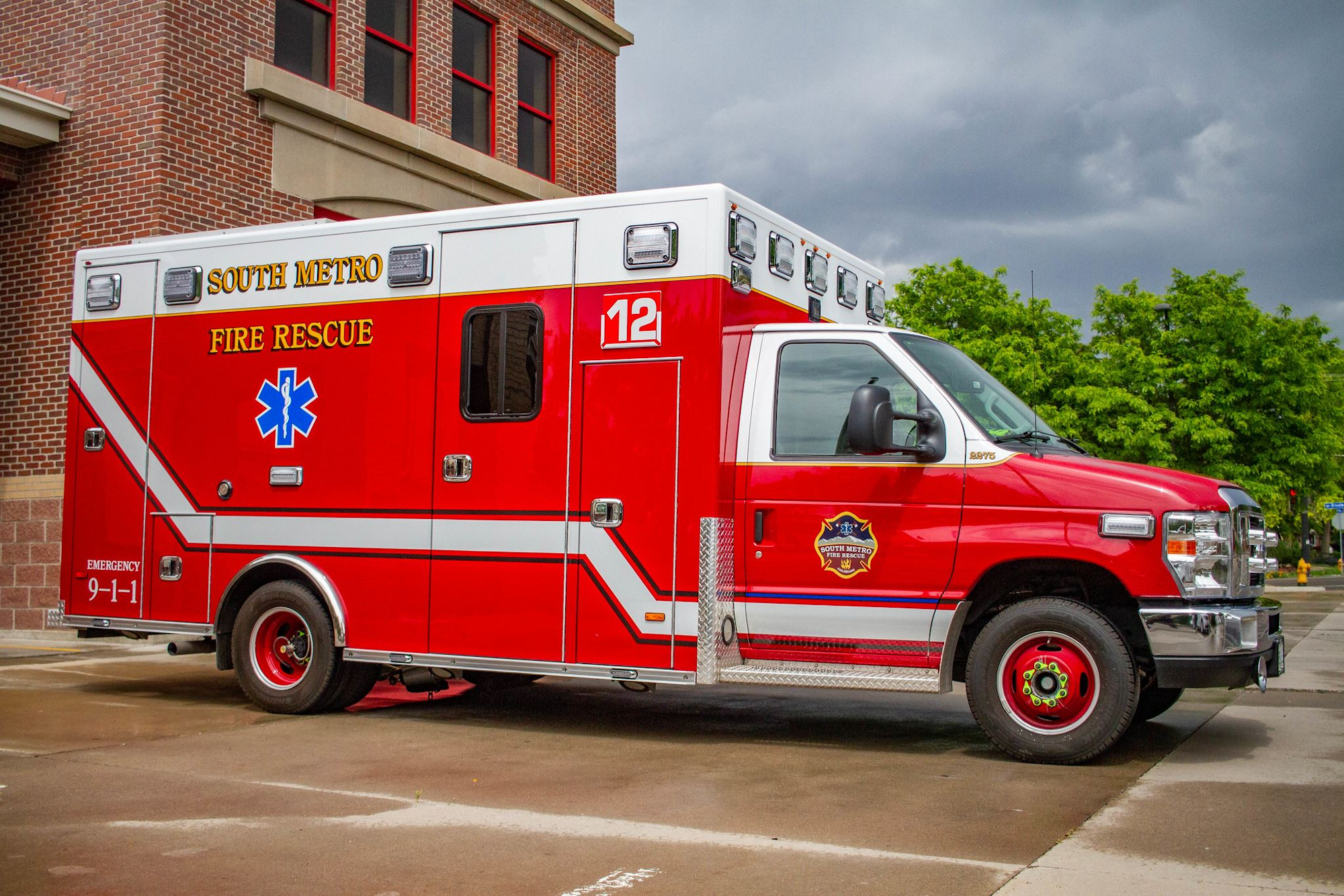 Red fire rescue ambulance parked outside a brick building, with "South Metro Fire Rescue" on the side.