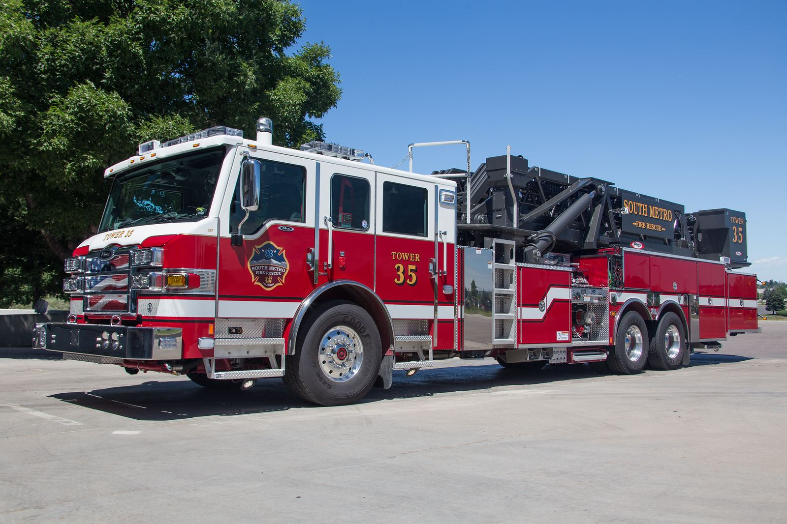 A red and white fire truck labeled "Tower 35" from South Metro Fire Rescue in a parking area.