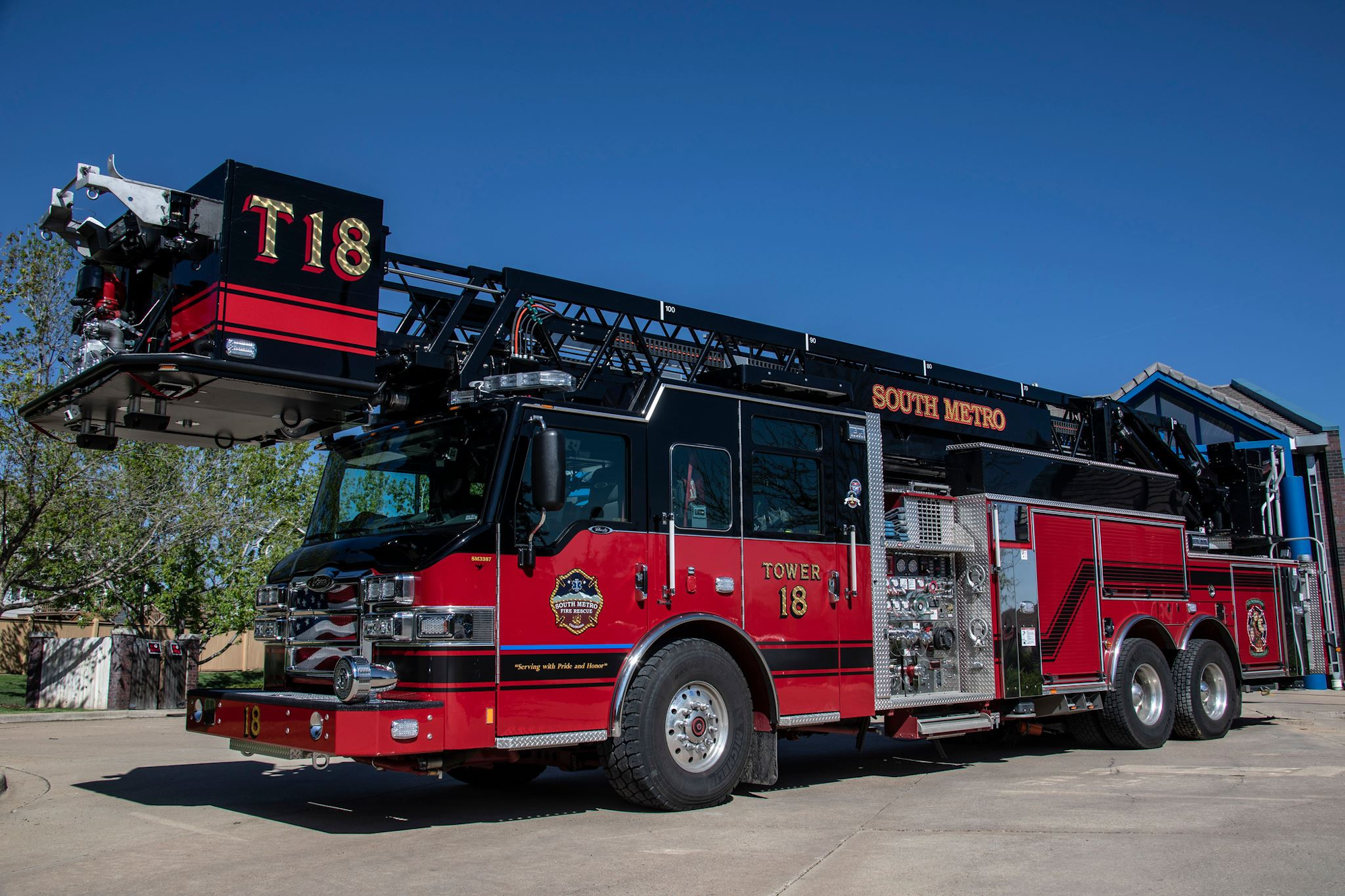 A red fire truck with "South Metro" and "Tower 18" markings parked outside.
