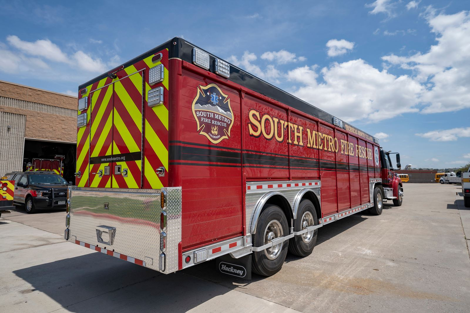 A red South Metro Fire Rescue truck is parked outside a building with its rear visible.