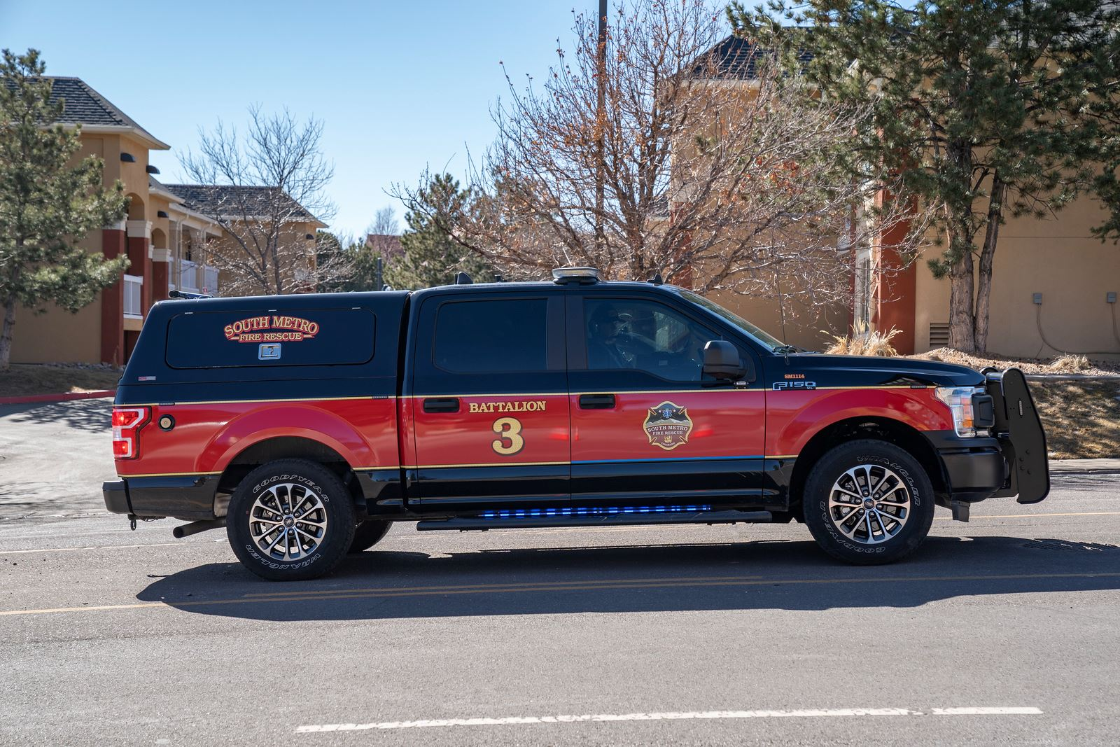 A red fire department vehicle labeled "South Metro Fire Rescue Battalion 3" parked on the street.