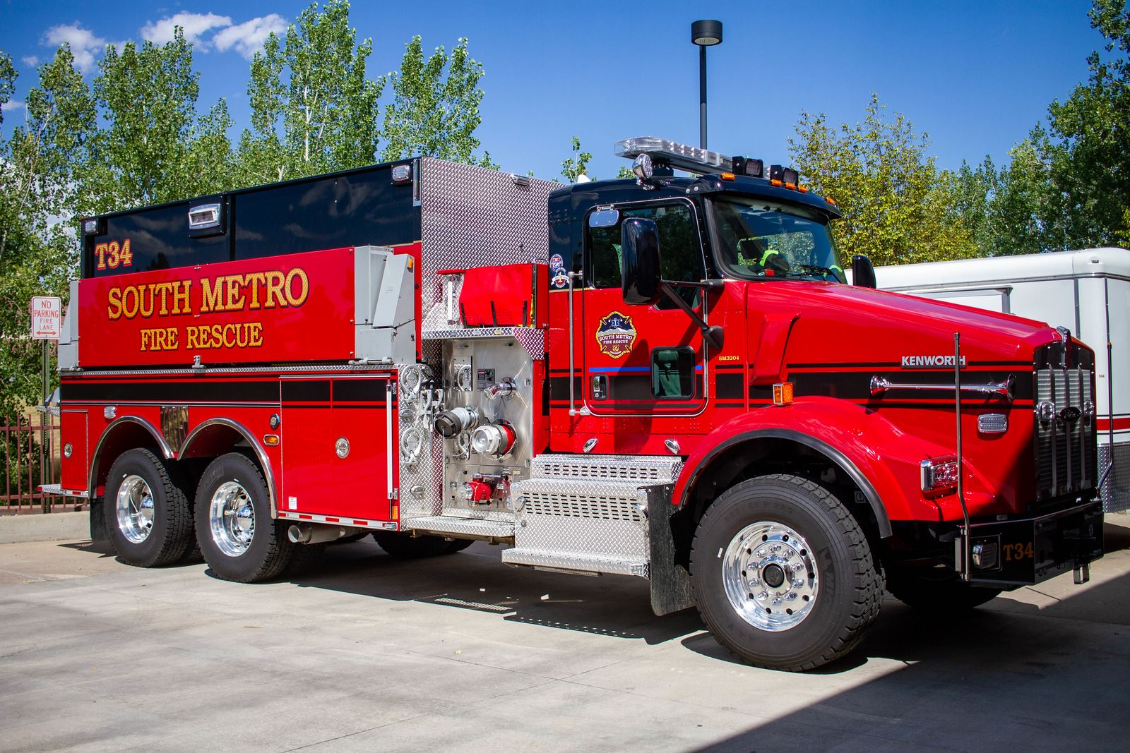 Red fire rescue truck with "South Metro Fire Rescue" text, parked outdoors.