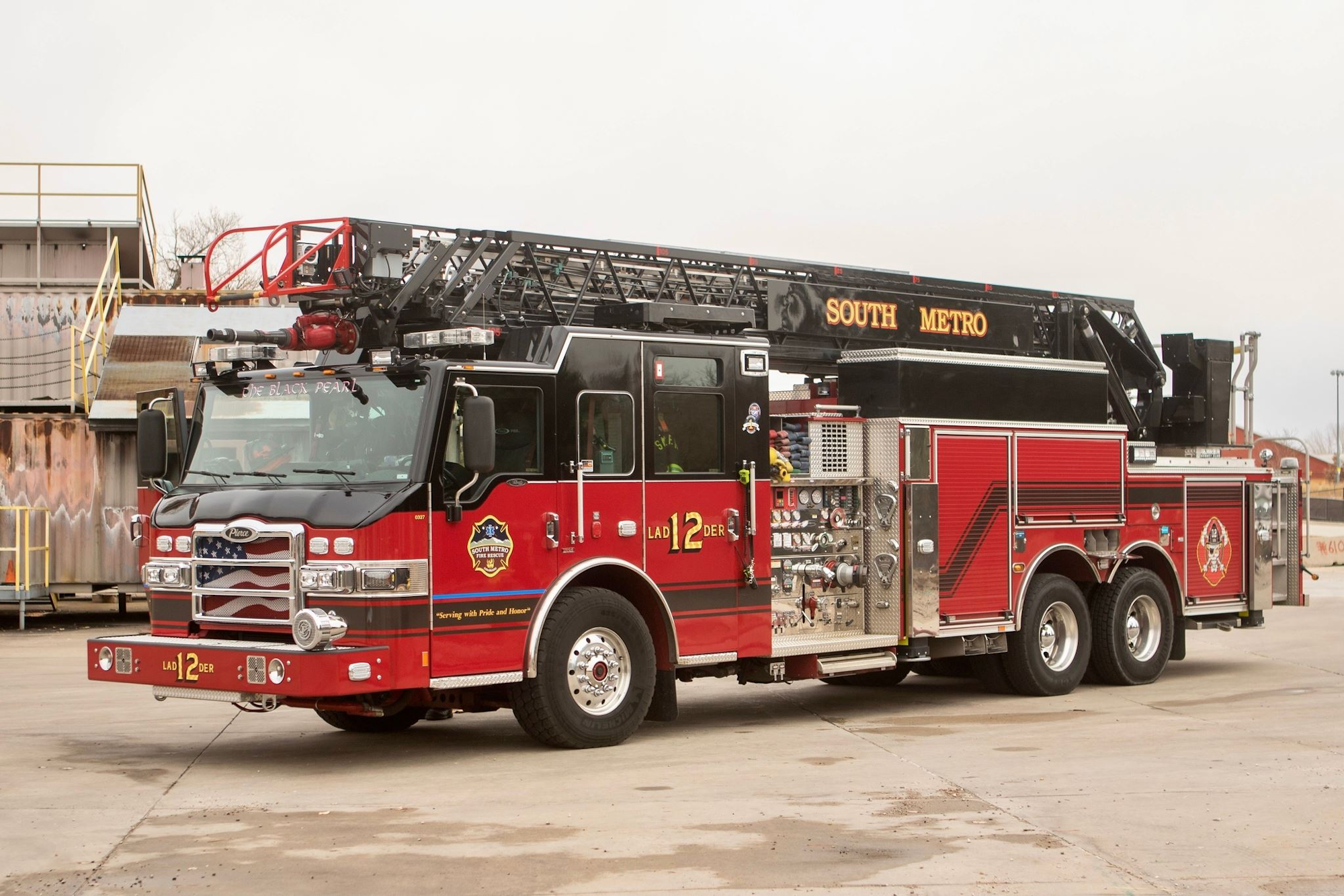 Red fire truck labeled "Ladder 12" with "South Metro" text on the ladder.