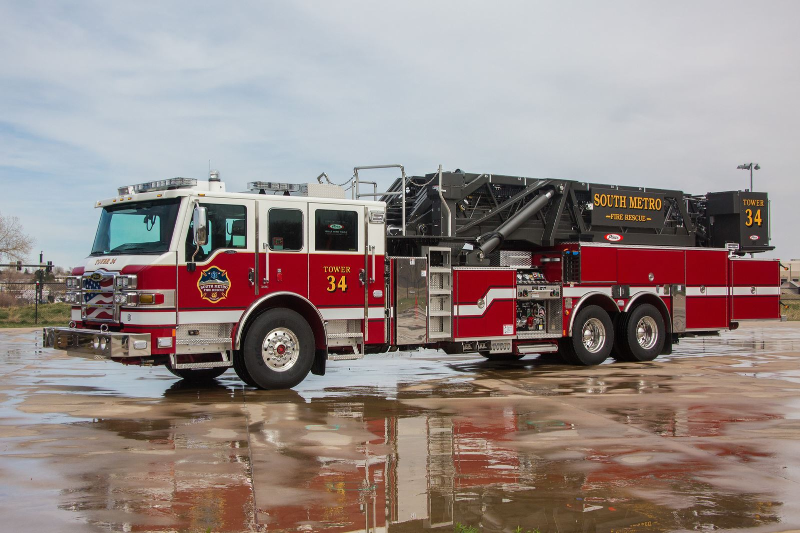 A red and white fire truck labeled "Tower 34" with "South Metro Fire Rescue."