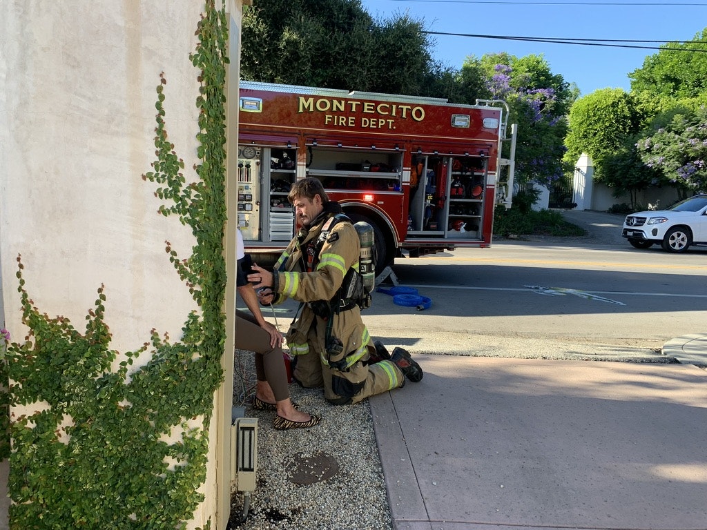 May contain: car, transportation, vehicle, clothing, footwear, shoe, plant, potted plant, adult, male, man, person, fire truck, truck, and city