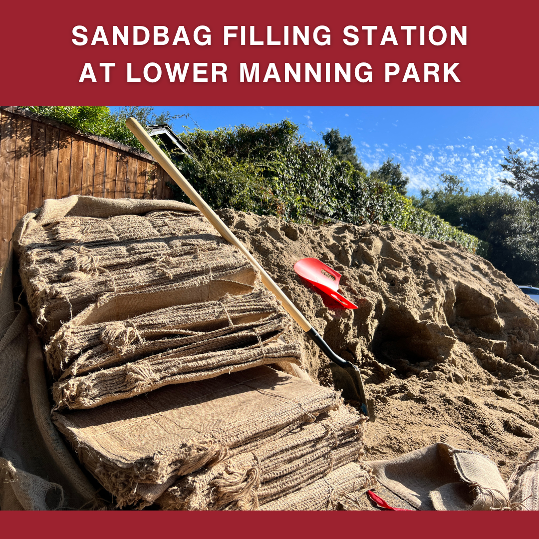 Sandbags and a shovel at a filling station in Lower Manning Park, with a sandy mound in the background.