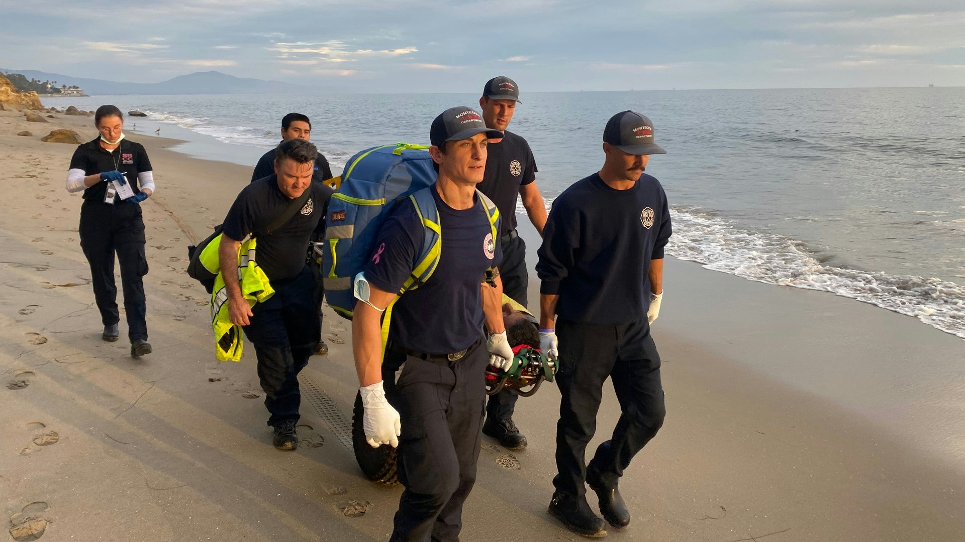 May contain: clothing, glove, footwear, shoe, baseball cap, cap, hat, adult, male, man, person, accessories, bag, handbag, and helmet