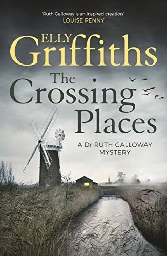 Book cover: "The Crossing Places" by Elly Griffiths. Features a windmill, dark sky, and reeds. A Dr. Ruth Galloway mystery.