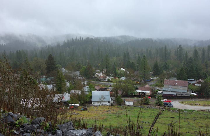 Overlook of town of Volcano with houses among trees.