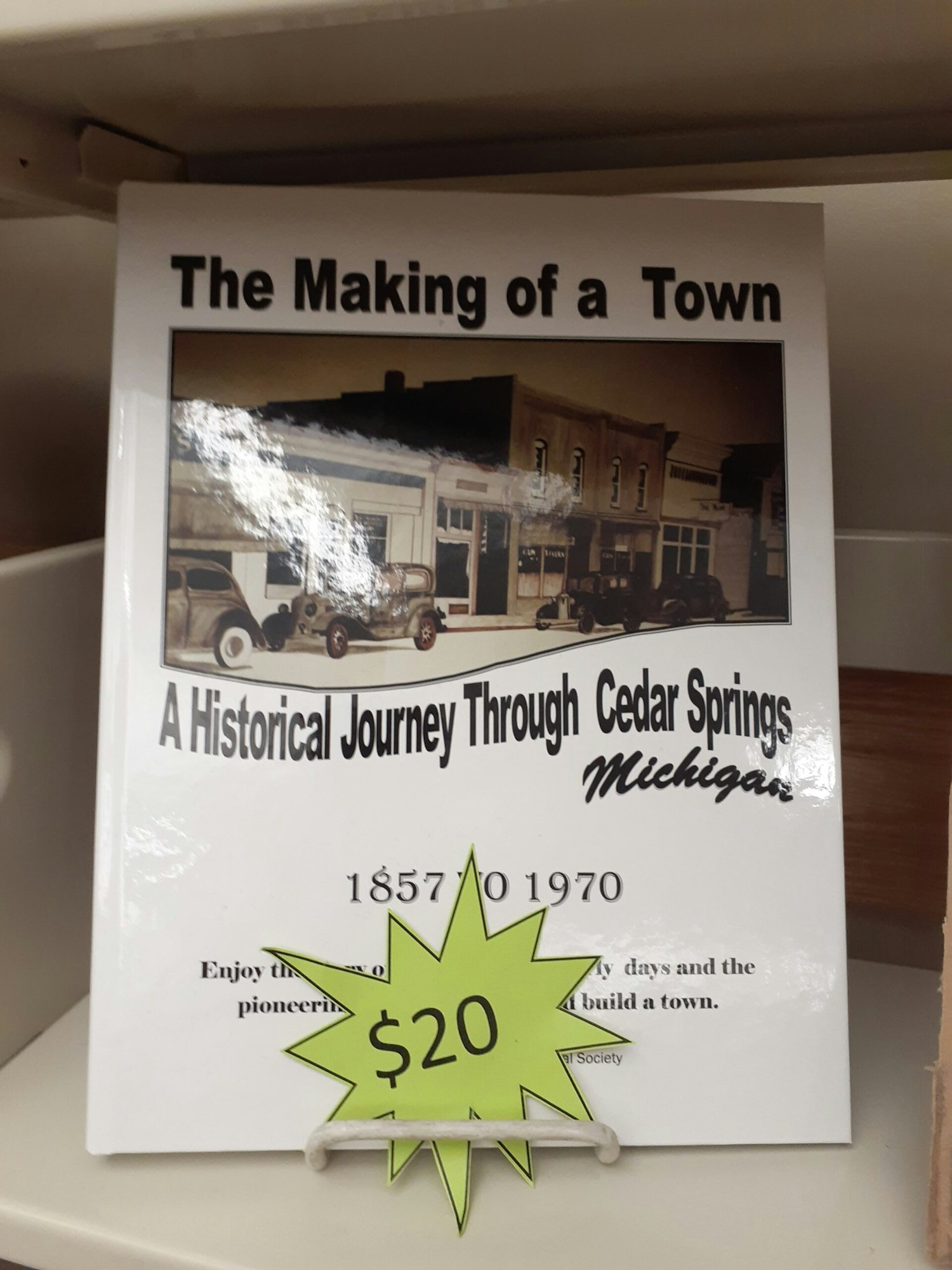 A book titled "The Making of a Town: A Historical Journey Through Cedar Springs, Michigan," priced at $20.