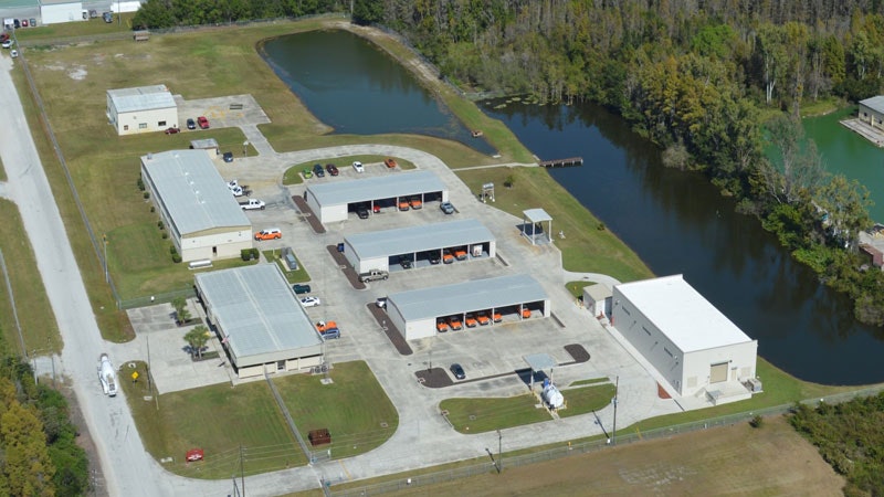 May contain: outdoors, architecture, building, aerial view, nature, lake, water, transportation, truck, and vehicle