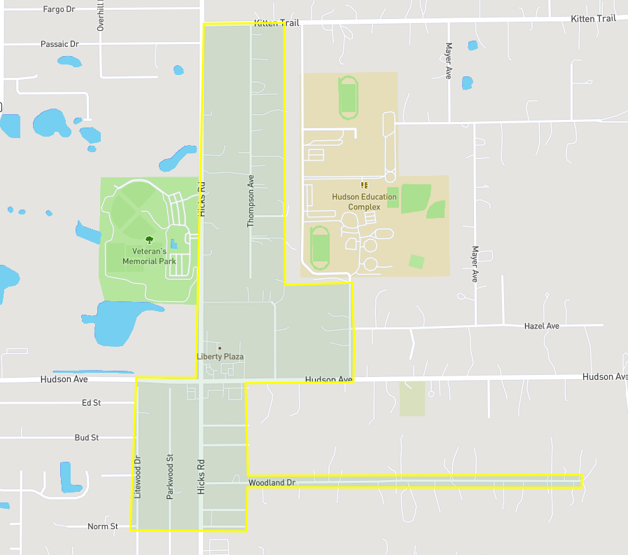 The image shows a map section highlighting streets, parks, and an education complex in a neighborhood layout.