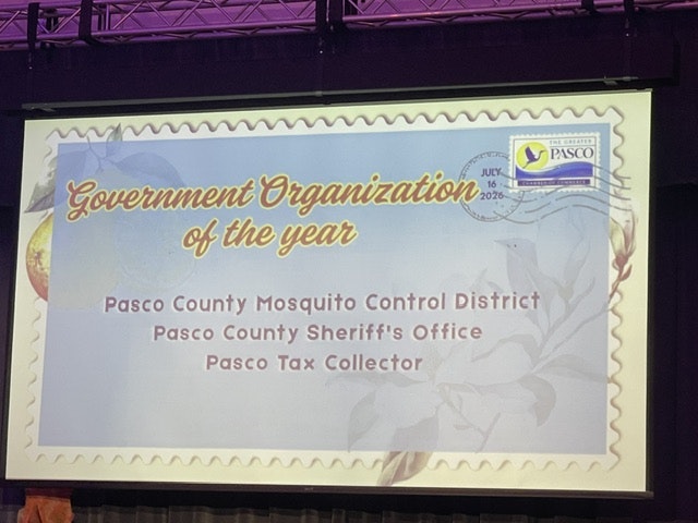 The image displays an award for "Government Organization of the Year" for three Pasco County entities: Mosquito Control, Sheriff's Office, and Tax Collector.