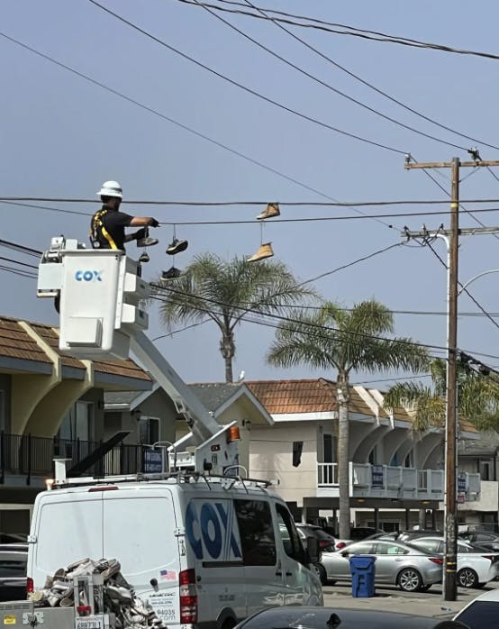 May contain: person, worker, utility pole, machine, and wheel