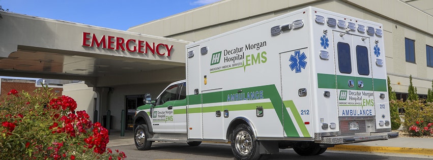 An ambulance parked outside an emergency department entrance.