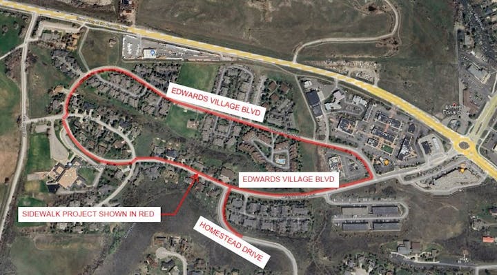 An aerial map highlighting a planned sidewalk project in red.