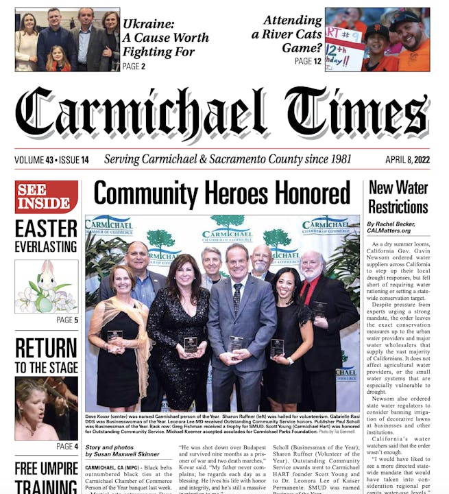 A newspaper front page with headlines about community heroes, Easter, a play, and water restrictions.