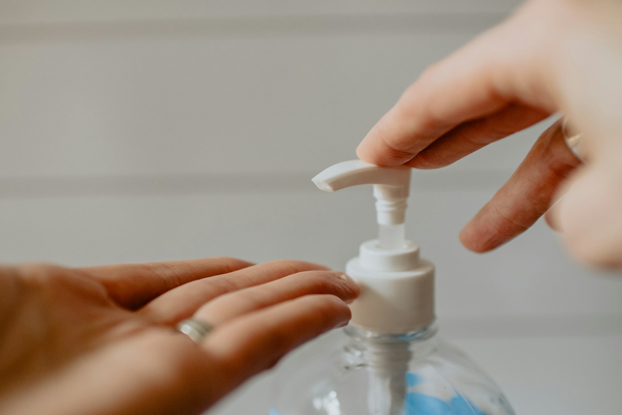 May contain: finger, hand, person, body part, lotion, and bottle