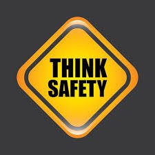 A yellow diamond-shaped sign with "THINK SAFETY" written on it.