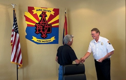 Chief Delfs receives 15-year service pin from Chairman Castaneda 06-26-25.