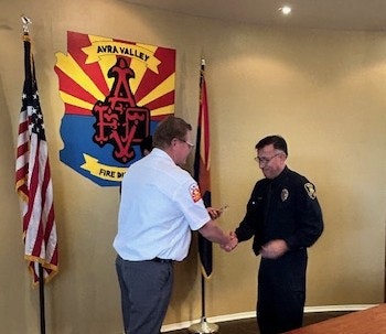 Chief Delfs congratulates Firefighter Luke Leon 2-26-26