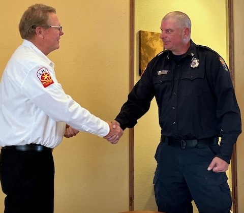 Captain Marc Albrecht receives 20-YR pin from Chief Delfs.
