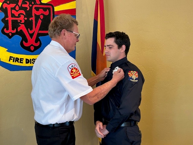 Chief Delfs pins badge for Firefighter Alexander Prato 06-26-25