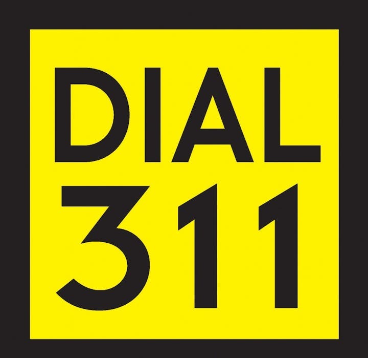 Yellow sign with "DIAL 311" in bold black letters.