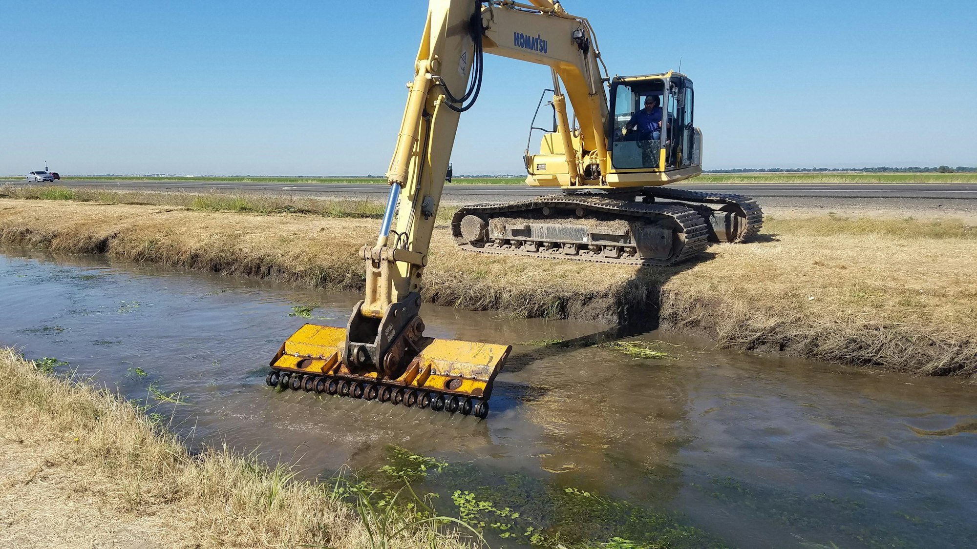 May contain: bulldozer, tractor, vehicle, transportation, person, and human