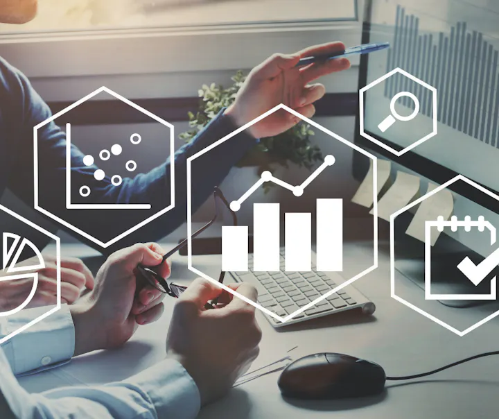 The image shows hands working with data analysis and charts, alongside icons representing statistics and productivity.