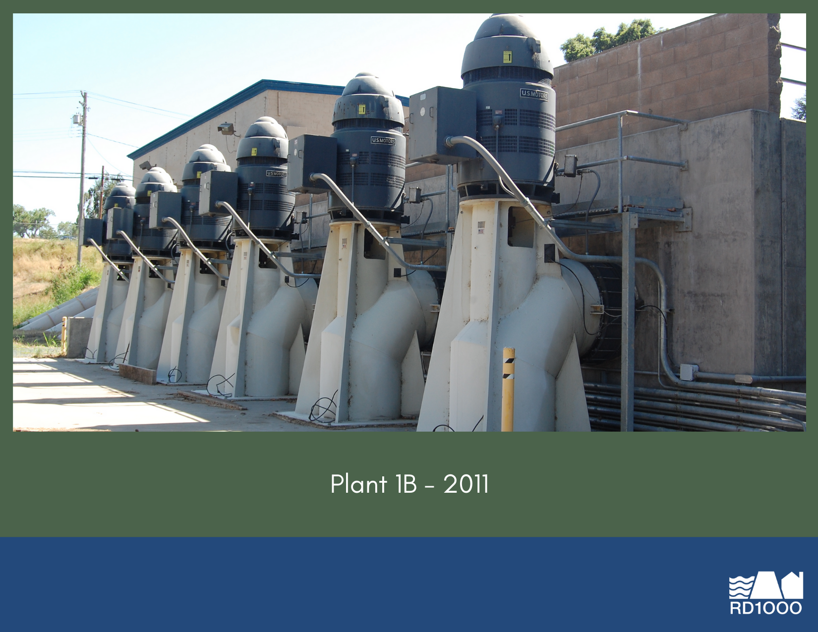 The image shows a row of large pumps or motors installed at a facility marked "Plant 1B - 2011."