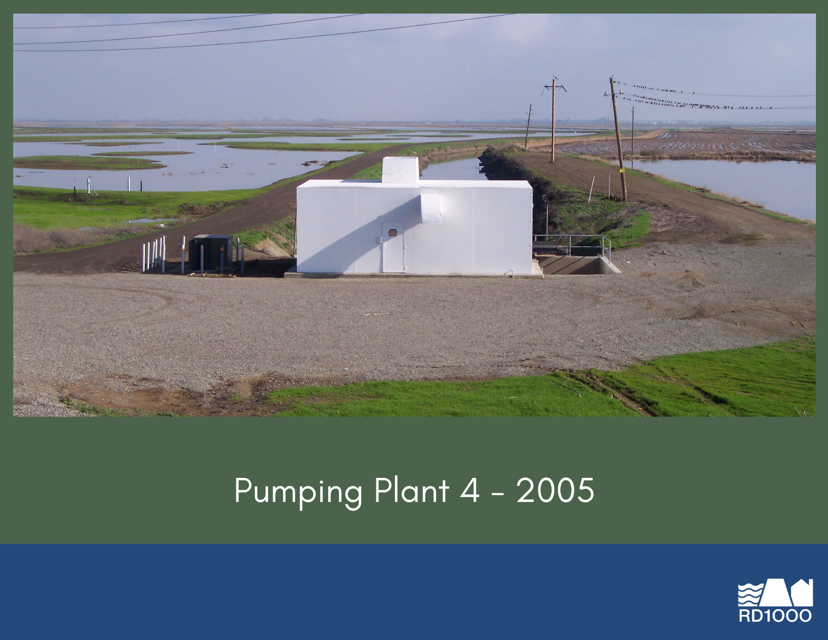 An image of a pumping plant from 2005, set in a green landscape with water visible in the background.