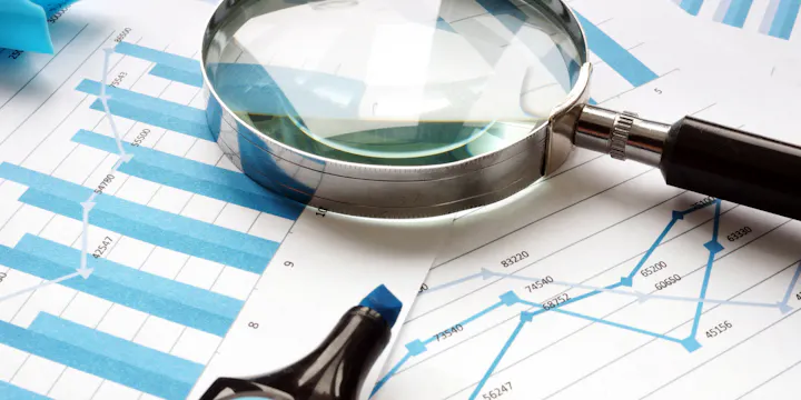 Magnifying glass on paperwork