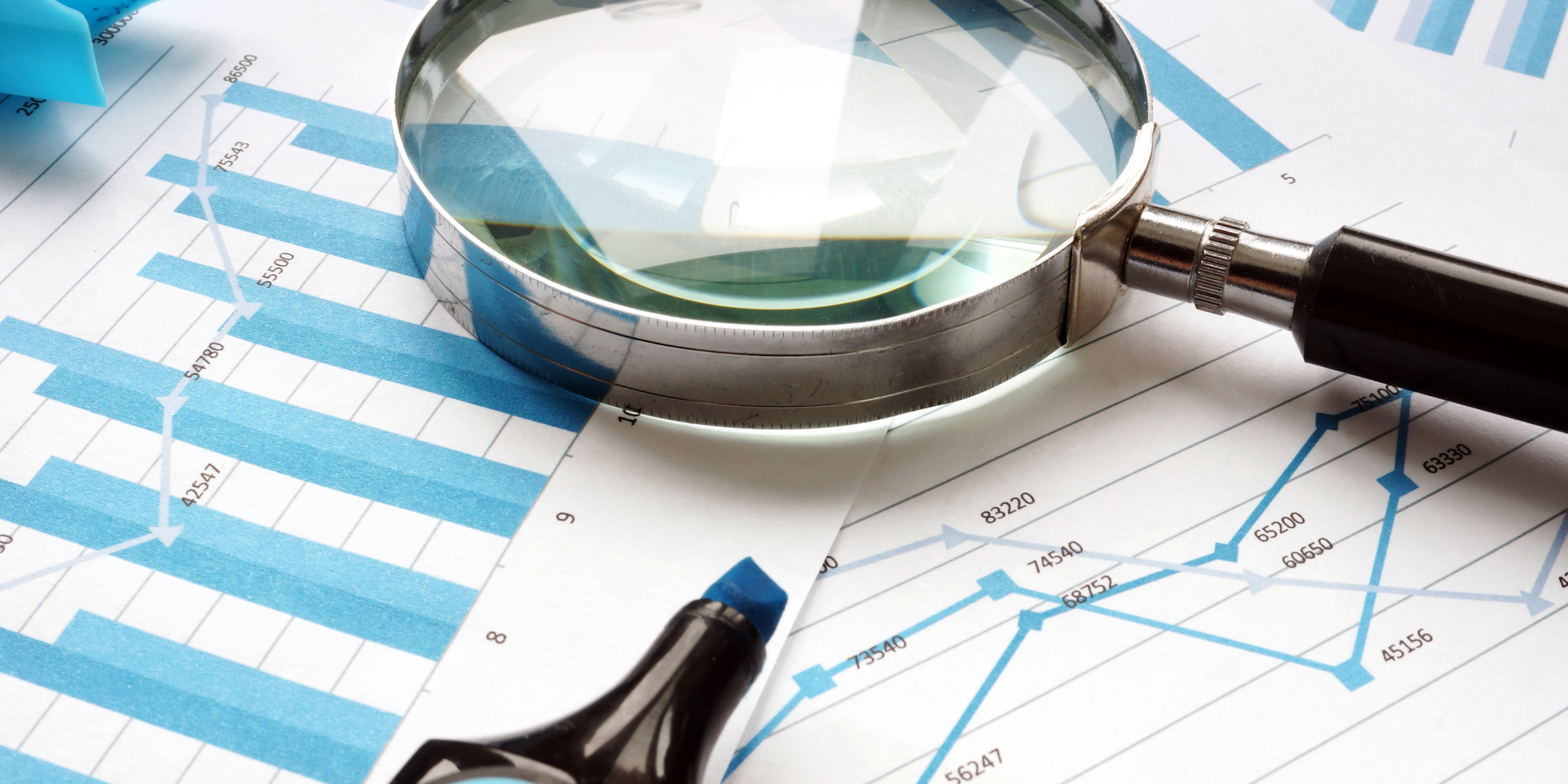 Magnifying glass on paperwork