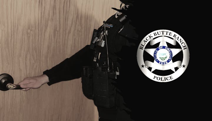 A person in uniform opening a door; "Black Butte Ranch Police, State of Oregon" emblem visible.