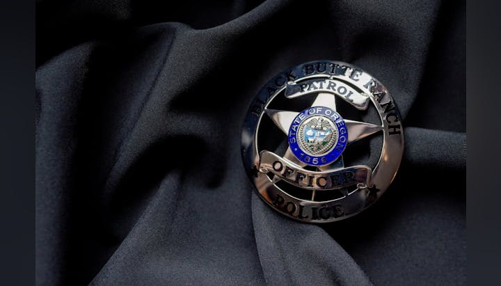 Police badge for Black Butte Ranch Patrol, Oregon, on a black fabric.