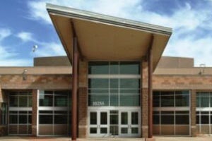Modern building entrance with large glass doors and windows.